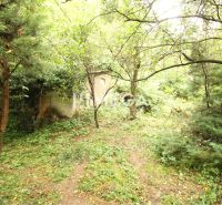 Residential land plots on Šípková Street in Košice IV, surrounded by dense trees and vegetation.