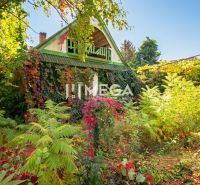 A family house in Petrovce surrounded by dense vegetation and climbing plants on the facade.