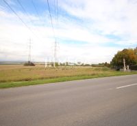 Extensive residential land by the road, in the village of Mokrance, with electrical lines.
