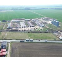 Aerial view of the production facilities in Hriadky surrounded by fields and a road.