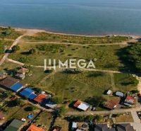 Aerial view of residential plots near a water body in the village of Vinné.