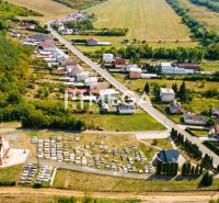 Aerial view of plots - housing in Slovenská Volová, surrounded by greenery and roads.