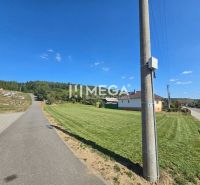 A road in Slovenská Volová with greenery, houses, and a church, Land - residential.