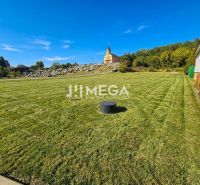 Residential plots in Slovenská Volová with a church and cemetery in the background.