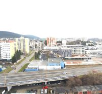 Humenné city, Štefánikova street, shows a view of commercial spaces and the highway.