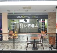 Commercial spaces with street food advertising in a shopping center.