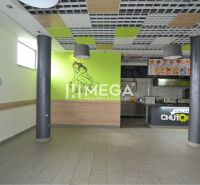 Interior of commercial spaces with wall decorations and an open kitchen.