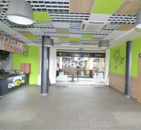 Commercial spaces with a dining counter, wooden decor flooring, colorful interior elements.