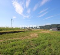 Plots - residential on Hámorská Street in Snina, with grassy area and view of the hills.