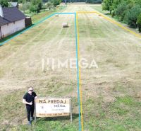 A plot for residential use in Jasenov with fencing and surrounding greenery.