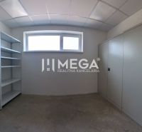 A small room with shelves and cabinets, suitable for storage in an office.