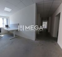 Offices with desks and chairs, with a view of the city through the window.