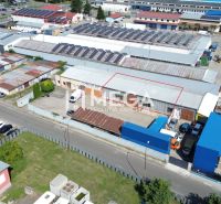 The industrial zone on Fidlikova Street in Humenné includes warehouses and halls with solar panels.