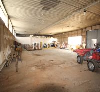 Warehouses and halls with concrete-look flooring, large windows, various equipment and materials.