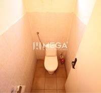Toilet with ceramic tiles in Offices, view into an enclosed space.