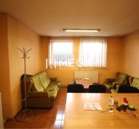 Offices with wood-patterned flooring, sofas, and a table with chairs.