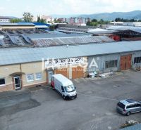 Office complex on Fidlikova Street in Humenne with parking and solar panels.