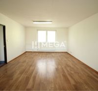 Spacious office with wood-patterned flooring and white walls.