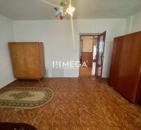 A room in a family house with wardrobes, light, and a wooden decor floor.