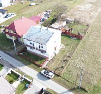 Aerial view of family houses in the village of Myslina, Myslina Street, with surrounding fields.
