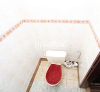 A bathroom with ceramic tiles in a family house.