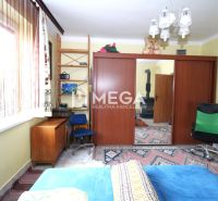 Interior of a family house with a desk, cabinets, and chairs.