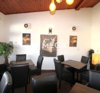 Gastro premises with comfortable chairs and decorations on the walls, floor with wooden decor.