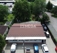 Gastro premises on Budovateľská Street in Vranov nad Topľou surrounded by cars and greenery.