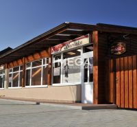 Gastro premises on Budovateľská Street in Vranov nad Topľou with wooden exterior cladding.