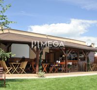 Gastro premises on Budovateľská Street in Vranov nad Topľou with garden seating.