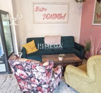 Gastro premises with colorful seats and a sign on the wall, floor with wooden decor.