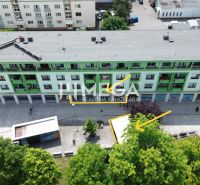 A building with commercial spaces and a pedestrian zone at Freedom Square in Vranov nad Topľou.