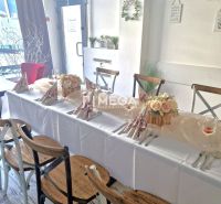 Stylish gastro spaces with wood-decor flooring and a decorated table for celebrations.