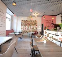 Interior of gastro spaces with decorative walls, flowers, and comfortable seating.