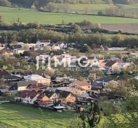 An aerial view of the village Lackovce surrounded by agricultural and forest lands.