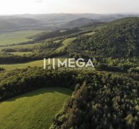 Aerial view of agricultural and forest lands surrounding Lackovce, with extensive green landscape.