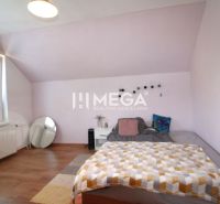 A bedroom in a family house with a wooden decor floor and purple walls.