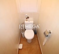 Bathroom with toilet and simple accessories in a 4-room apartment.