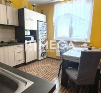 A kitchen with yellow walls and a wooden decor floor in a 4-room apartment.