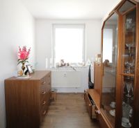 A room with cabinets and a wooden decor floor in a 4-room apartment.