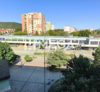 The view from a 3-room apartment in Humenné of the surrounding buildings and greenery.