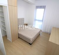 Bedroom in a 3-room apartment with wood-patterned flooring and storage space.