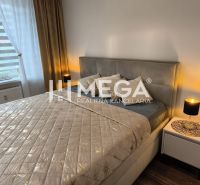 A bedroom in a 3-room apartment with a bed, nightstands, and a floor with a wood decor.