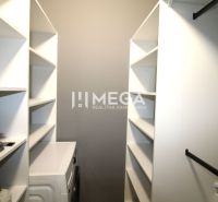 A wardrobe in a 3-room apartment with shelves and a washing machine.