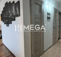 Interior of a 3-room apartment with a stone-clad wall and a floor with a wooden decor.