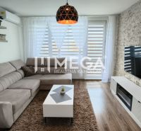 Living room in a 3-room apartment with a corner sofa and a wooden decor floor.