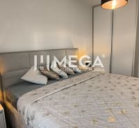 A bedroom in a 3-room apartment with a comfortable bed and a lamp on the nightstand.