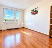 A room in a 4-room apartment with a wooden decor floor and light-colored walls.