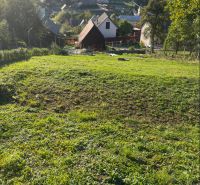 Košecké Podhradie offers residential plots with rural architecture and surrounding greenery.