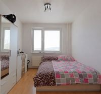 Bedroom in a 3-room apartment with a wardrobe and a wooden decor floor.
